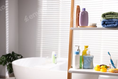 Preview: Baby accessories and bathing products on rack in bathroom. Space for text