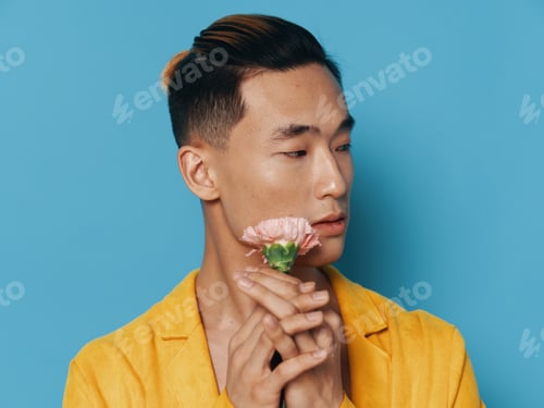 Preview: a man of Asian appearance with a light flower and a yellow coat