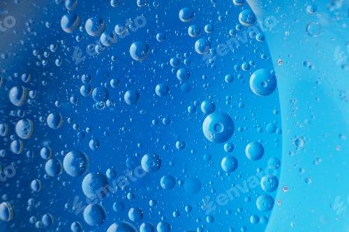 Preview: abstract light blue background with oil circles . bubbles of water close up .