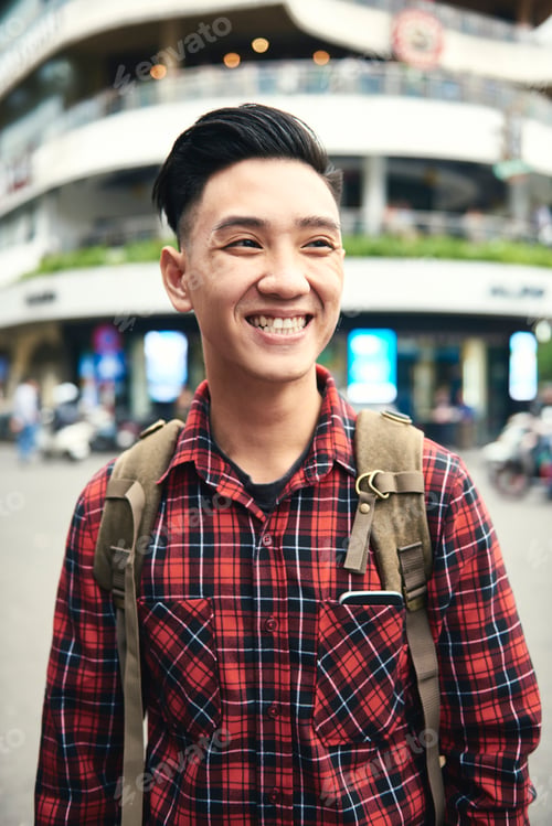 Preview: Young Asian man smiling and looking away
