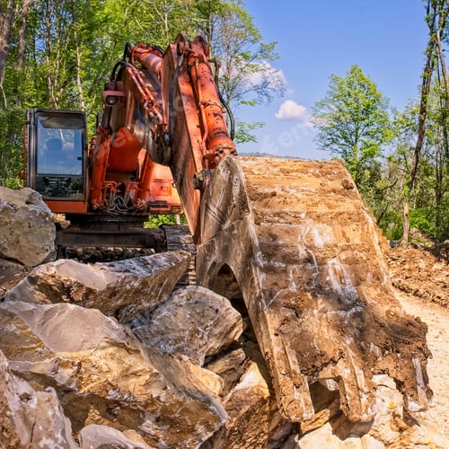 Preview: Excavator loader machine at road construction site.