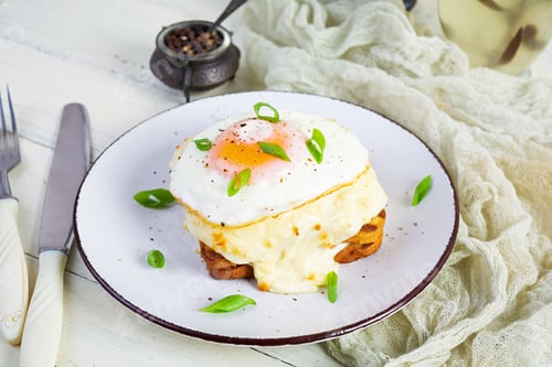 Preview: Delicious breakfast. Hot french toast with ham and bechamel sauce - croque madame