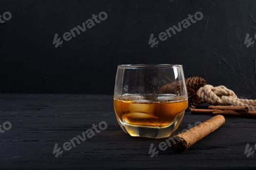 Preview: Glass of whiskey with ice on dark background