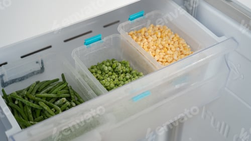 Preview: Frozen vegetables preserving freshness in refrigerator drawer: peas, corn, and green beans