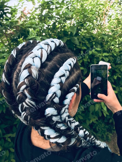 Preview: A girl with blue braids using white Smartphone. || Outdoors || Natural light || Outside || Hand