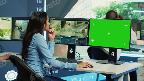Preview: Indian woman working with surveillance footage and greenscreen on computers
