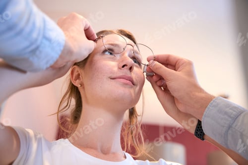 Preview: Elegant pretty lady is receiving qualified consultation in the optical shop