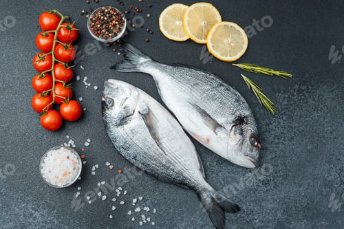 Preview: Fresh raw dorado fish with tomatoes lemon and spices on black background