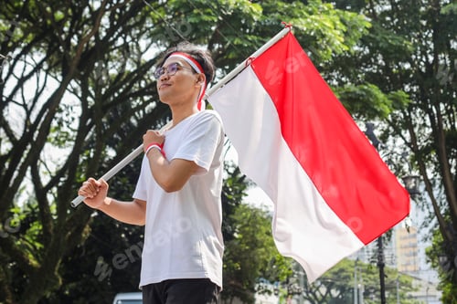 Preview: Young Man Holds Red and White Flag