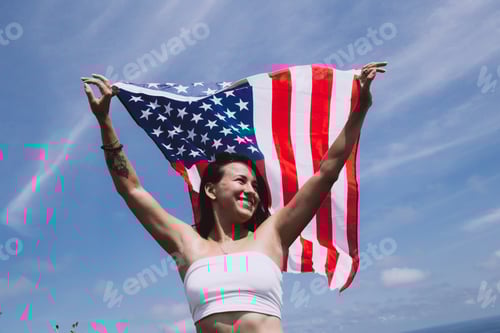 Preview: Woman Celebrates Holding American Flag High on Hilltop