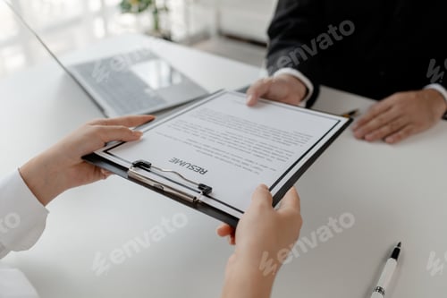 Preview: Woman candidate interview with HR manager in office, Examiner reading a resume during job interview