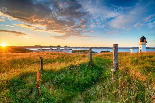 Preview: Beautiful sunset over the lighthouse and coastguard cottages at Arnish Point