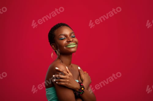 Preview: Exotic afro american young woman posing on red, panorama