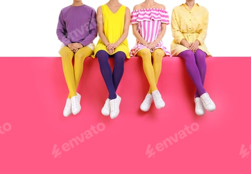Preview: Group of women wearing bright tights and stylish shoes sitting on color background, closeup