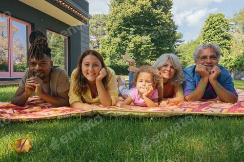 Preview: Happy multigenerational family relaxing outdoors together