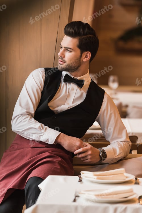 Preview: Waiter leaning on chair and looking away