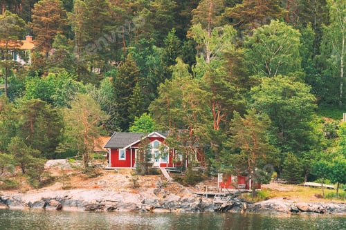 Preview: Sweden. Beautiful Red ASwedish Wooden Log Cabins Houses On Rocky Island Coast In Summer. Lake Or