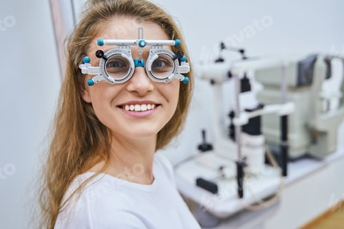 Preview: Cheerful young woman wearing optical trial lens frame
