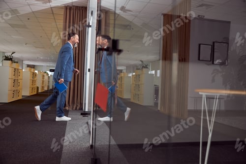 Preview: Happy adult caucasian man is working in a modern office