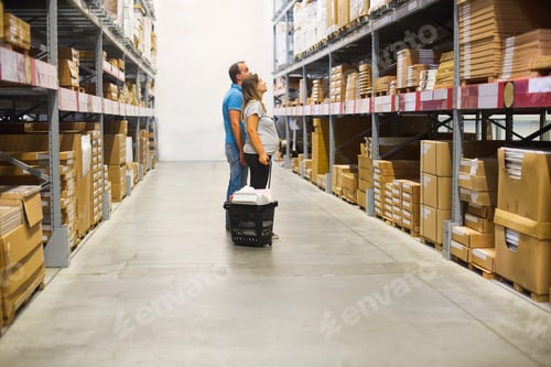 Preview: Young pregnant couple in diy store. Renovation and home concept