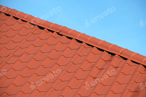 Preview: Closeup of house roof top covered with metallic shingles.Tiled covering of building