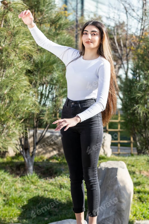 Preview: Beautiful girl holding her hands up and looking at the camera
