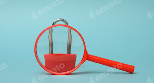 Preview: Metal lock stands on a red plastic magnifying glass on a blue background.