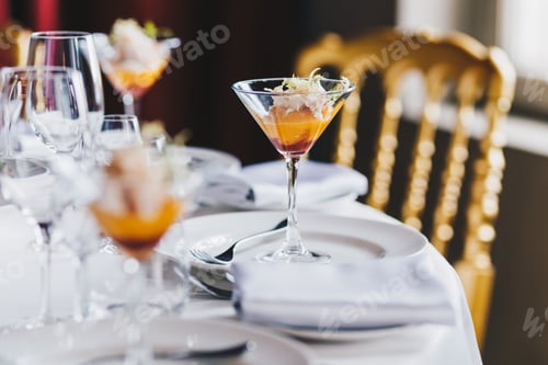 Preview: Festive decorated table with expensive cutlery, glass of alcoholic cocktail