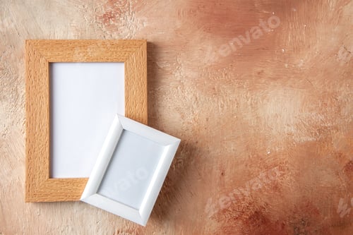 Preview: Close up view of small and big colorful photo frames on the right side hanging on pastel colors wall