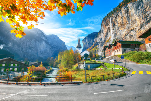 Preview: Stunning autumn view of Lauterbrunnen village with awesome waterfall Staubbach and Swiss Alps