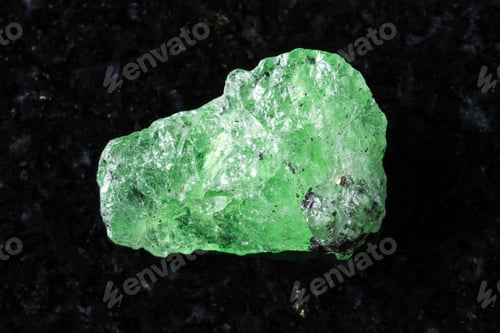Preview: sample of rough tsavorite garnet mineral on black
