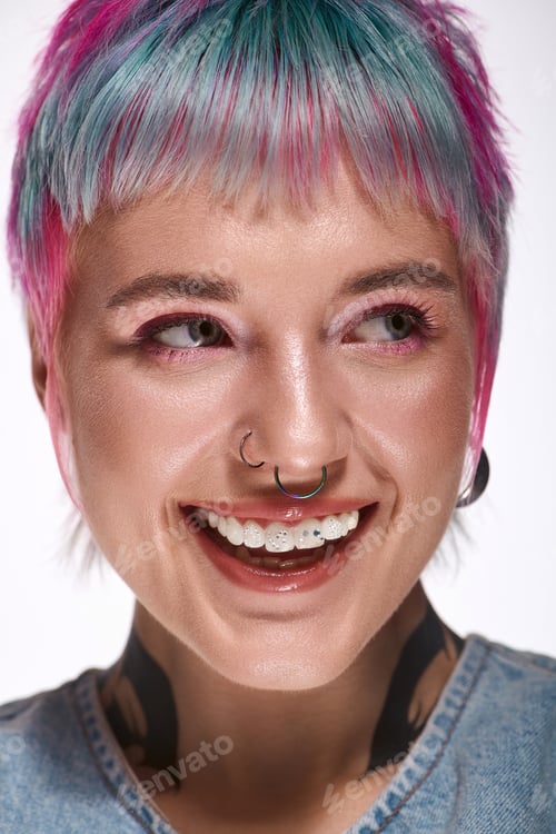 Preview: Young woman with vibrant hair showing joy in a modern studio setting