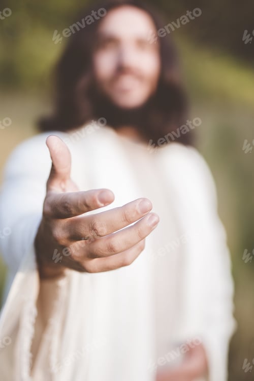 Preview: Vertical shot of Jesus Christ reaching out with a blurred background