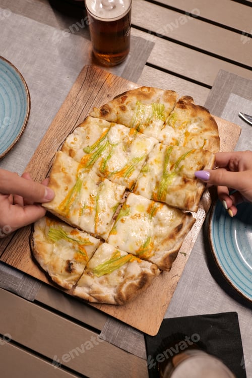 Preview: Italian pizza served on a restaurant table with beer