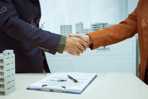 Preview: A businessman shakes hands with customer in the sales office after agreeing sign contract to buy