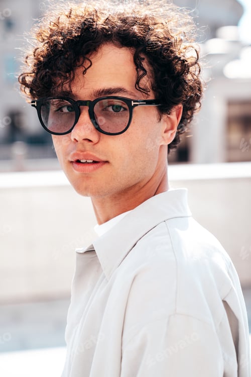Preview: Attractive man with curly hairstyle outdoors