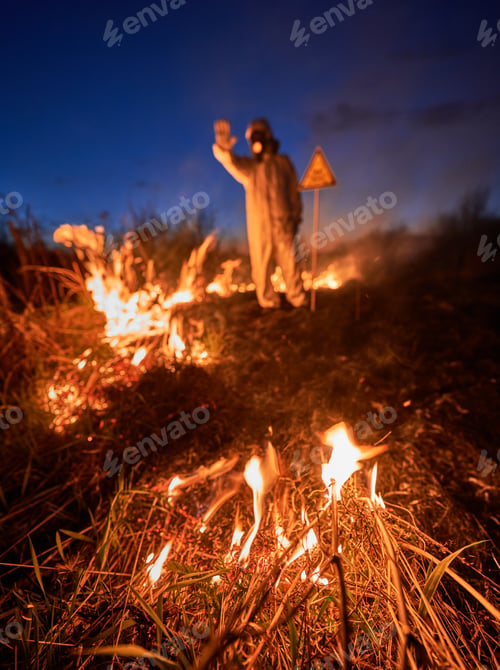 Preview: Firefighter ecologist working in field with wildfire.