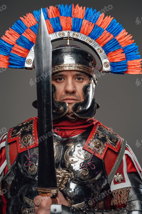 Preview: Proud roman soldier with gladius posing against gray background
