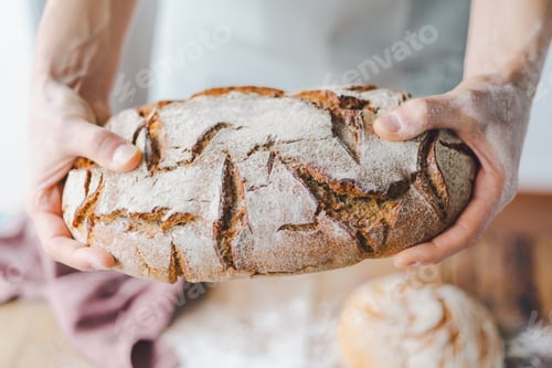 Preview: Baker or chef holding fresh made bread