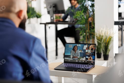 Preview: Project manager collaborating remotely with coworkers in online meeting