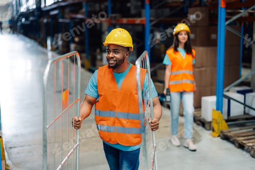 Preview: Diverse warehouse workers engaged in teamwork, optimism and equipment.