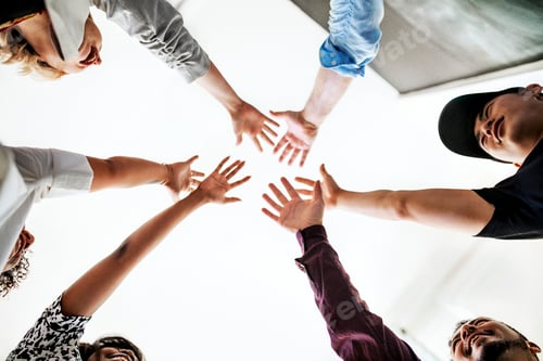 Preview: Happy team putting their hands together for success