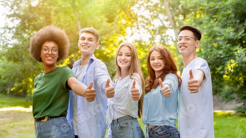 Preview: Group Of Multiethnic Teen Friends Standing Outdoors Showing Thumbs Up At Camera