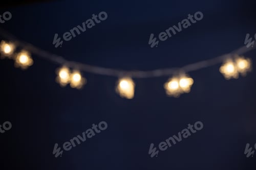 Preview: Blurred Christmas lights over dark blue background