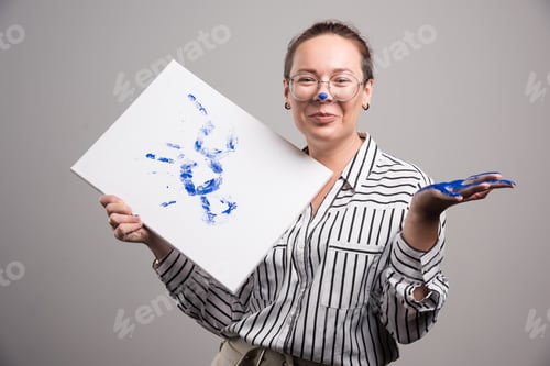 Preview: Woman with canvas of picture her hand on gray background