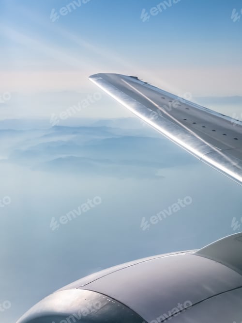 Preview: wing of aircraft and view of mountains and sea