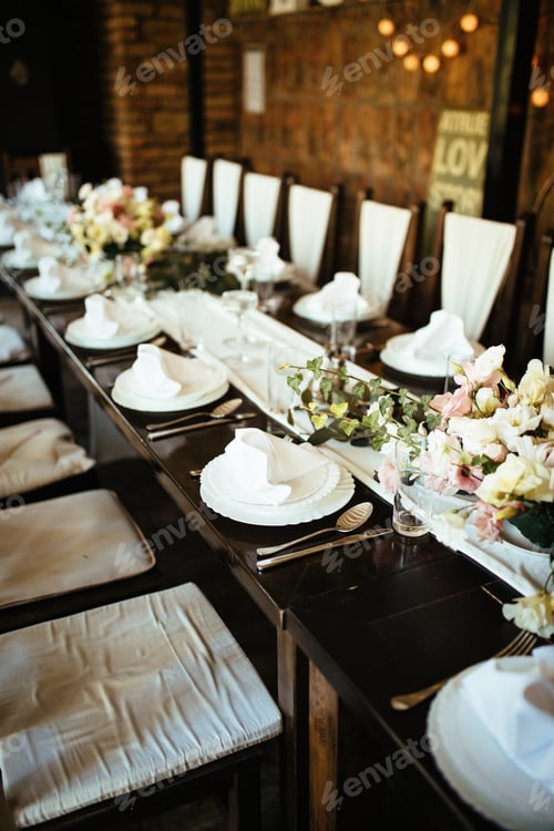 Preview: Table setting at rustic wedding reception.