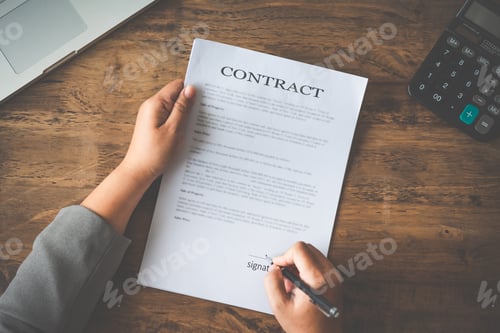 Preview: Hand holding pen signing contract in important documents.