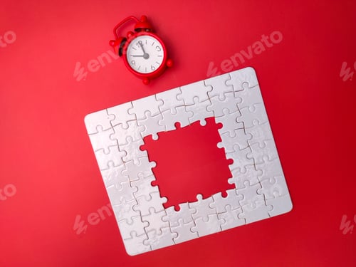 Preview: Concept red alarm clock and puzzle on red background