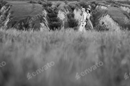 Preview: young couple a guy and a girl are walking in the mountain hills
